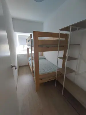 a small room with bunk beds and a window at Casa Sáner in Rábade