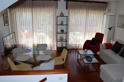 a living room with a table and a couch at Mártires de Carral in Santa María
