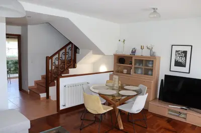 a living room with a table and a tv at Mártires de Carral in Santa María