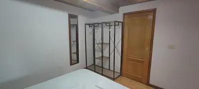 a room with a bed and a wooden door at Casa do Outeiro de Aguil in Castro Caldelas