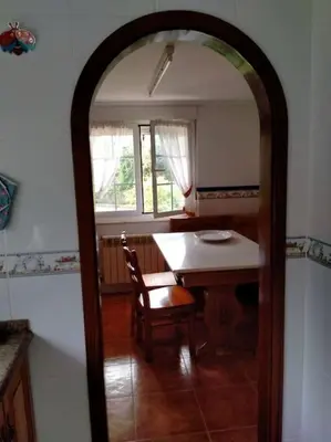 a dining room with a table and a table and chair at Preciosa casa en A Caridad in La Caridad