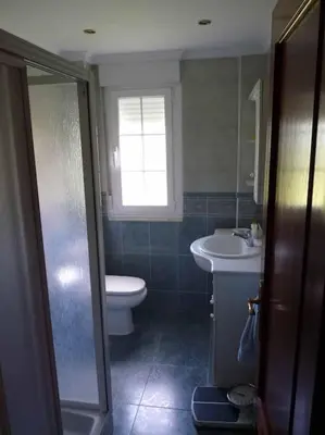 a bathroom with a toilet and a sink at Preciosa casa en A Caridad in La Caridad