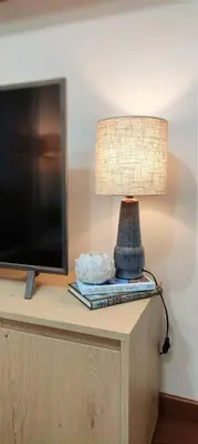 a lamp sitting on a table next to a tv at Apartamento de playa in San Ciprián