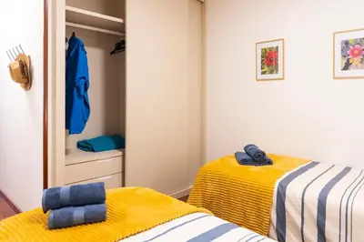 a bedroom with two beds and a closet at Apartamento de playa in San Ciprián