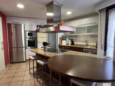 a kitchen with a table and a counter top at YourHouse Aldo in Ourense