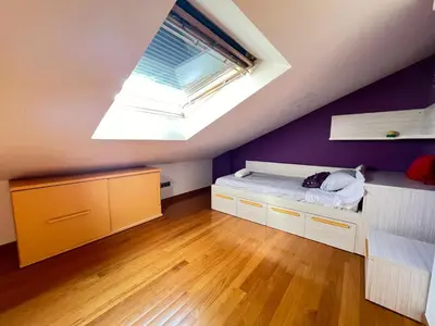 a attic bedroom with a bed and a skylight at YourHouse Aldo in Ourense