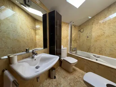 a bathroom with a sink and a toilet and a tub at YourHouse Aldo in Ourense