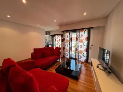 a living room with red furniture and a red couch at YourHouse Aldo in Ourense