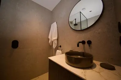 a bathroom with a sink and a mirror at Amando Perez Suites in Ribadeo