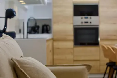a living room with a couch and an oven at Amando Perez Suites in Ribadeo