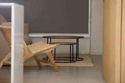 a table and a chair in a room at Amando Perez Suites in Ribadeo