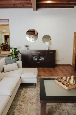 a living room with a white couch and a table at Casa Rouco in Melide