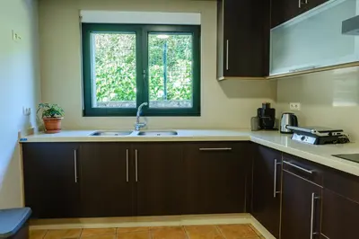 a kitchen with a sink and a window at Casa Rouco in Melide