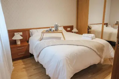 a hotel room with two beds with a table on it at Casa Rouco in Melide