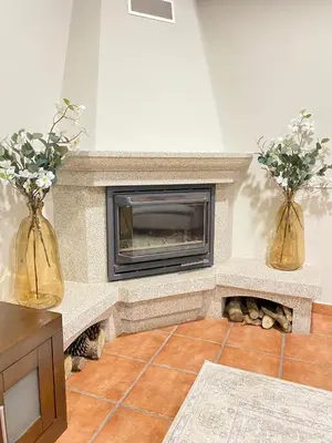 a living room with two vases with flowers in them at Casa Rouco in Melide