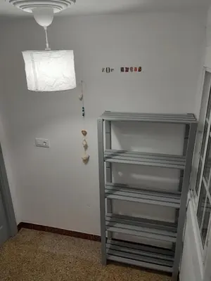 a empty shelf in a room with a light at Casa de Amigos in Picaraña