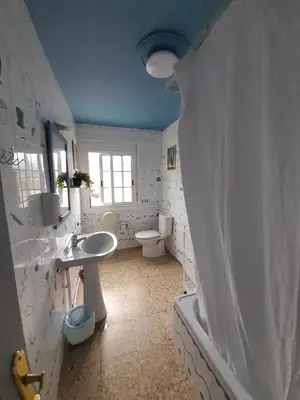 a bathroom with two sinks and a toilet at Casa de Amigos in Picaraña