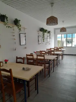 a row of tables and chairs in a restaurant at Casa de Amigos in Picaraña