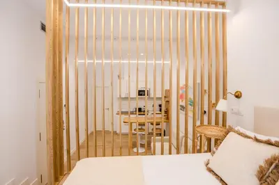 a bedroom with a bed and a dining room at Soños de Compostela in Santiago de Compostela