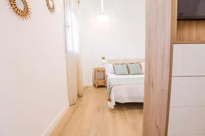 a small bedroom with a bed and a wooden floor at Soños de Compostela in Santiago de Compostela