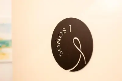 a black clock hanging on a white door at Soños de Compostela in Santiago de Compostela