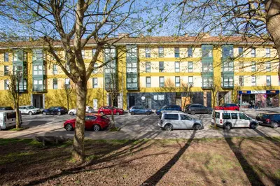 a parking lot with cars parked in front of a building at Soños de Compostela in Santiago de Compostela