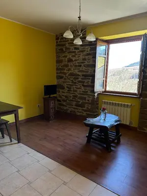 a house with a staircase leading to a door at Apartamentos Helenias in Boal