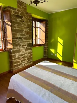 a living room with a couch and a table at Apartamentos Helenias in Boal