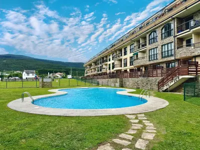 a swimming pool in front of a building at Apartamento Herosa 1 Spa in Barreiros