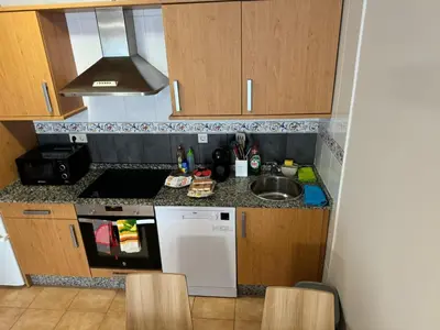 a small kitchen with a sink and a stove at Apartamento VILLA ANDRES in Villadaíde