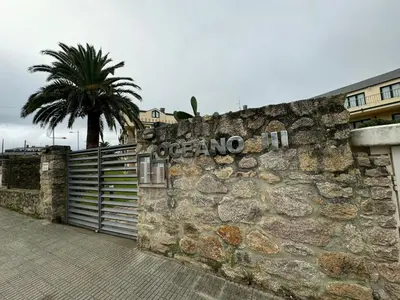 a stone wall with a sign on it with a palm tree at Apartamento VILLA ANDRES in Villadaíde
