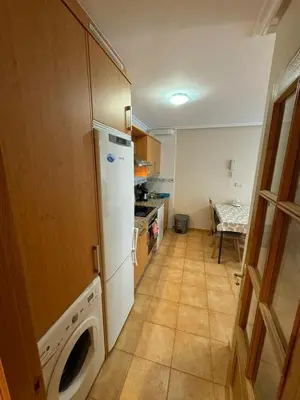a kitchen with a refrigerator and a washer and dryer at Apartamento VILLA ANDRES in Villadaíde