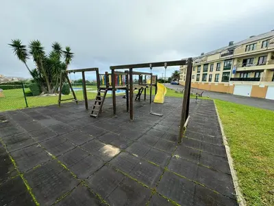 a park with a playground with a swing at Apartamento VILLA ANDRES in Villadaíde