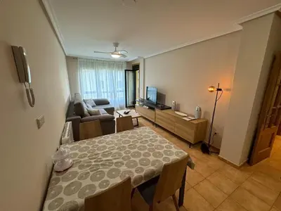 a living room with a table and a couch at Apartamento VILLA ANDRES in Villadaíde