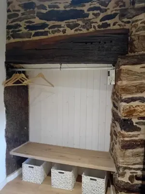 a white cabinet and a chair in a room at Casa do Outeiro in Friol