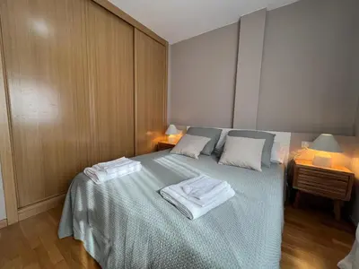 a bedroom with a bed with two towels on it at YourHouse Lagoa in Ourense