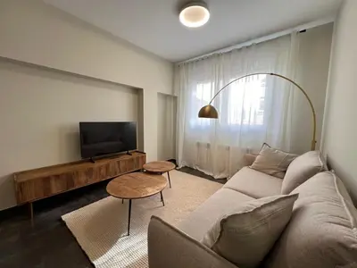 a living room with a couch and a flat screen tv at YourHouse Lagoa in Ourense