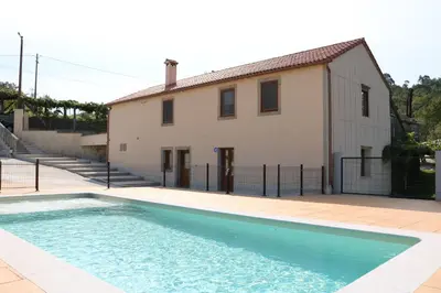 a house and a swimming pool in front of a house at A de Jose Luis in Reis
