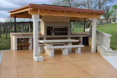 a picnic shelter with a picnic table and benches at A de Jose Luis in Reis
