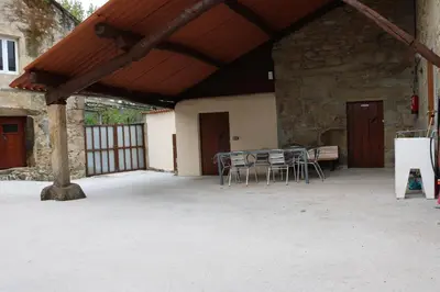 a patio with a table and chairs in a building at A de Jose Luis in Reis