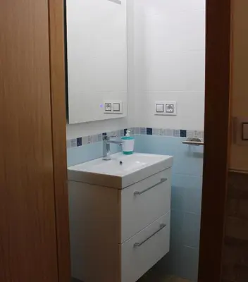 a bathroom with a white sink and a mirror at A de Jose Luis in Reis
