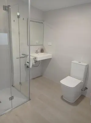 a bathroom with a toilet and a sink and a shower at LAR JARDÍN - Casas independientes con parking privado in Santiago de Compostela