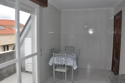 a white kitchen with white cabinets and a sink at Monte Faro El corazón de Galicia in Lalín