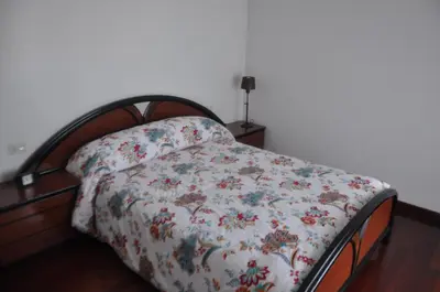 a bedroom with a bed with a wooden headboard at Monte Faro El corazón de Galicia in Lalín