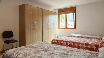 a room with two beds and a bunk bed at Albergue Castro Domum in Castrillo de Cabrera