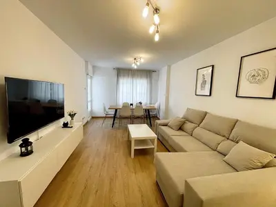 a living room with a couch and a flat screen tv at Lucus Urban Centre in Lugo