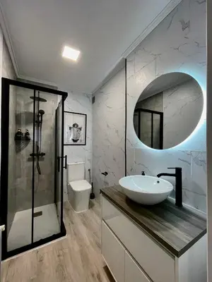 a bathroom with a sink and a shower with a mirror at Lucus Urban Centre in Lugo