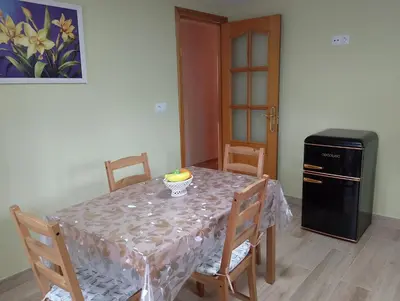a dining room with a table and a refrigerator at Casa Marcelino in Reinante