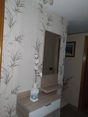 a bathroom with a mirror and a vase with flowers at Casa Marcelino in Reinante