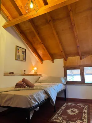 a bedroom with a bed in a room with wooden ceilings at La casa Azul in Allariz